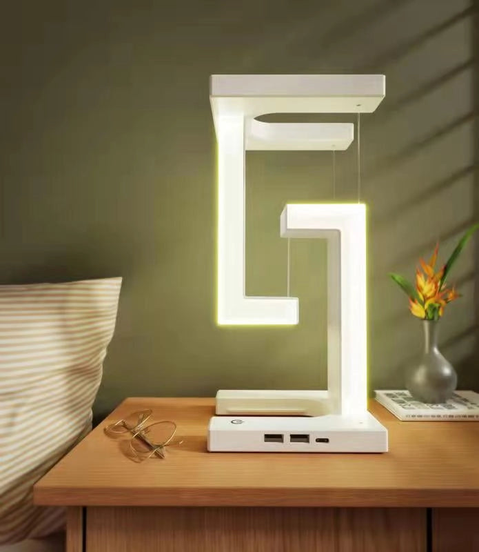 Creative wireless charging suspension table lamp by stcraftdigital, floating balance lamp for home or bedroom decor and tech use.
